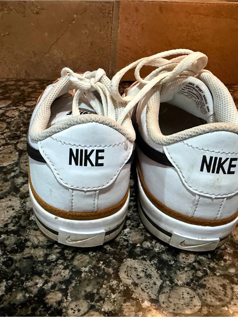 Nike White Low-Top Sneakers with Black Swoosh and Brown Trim